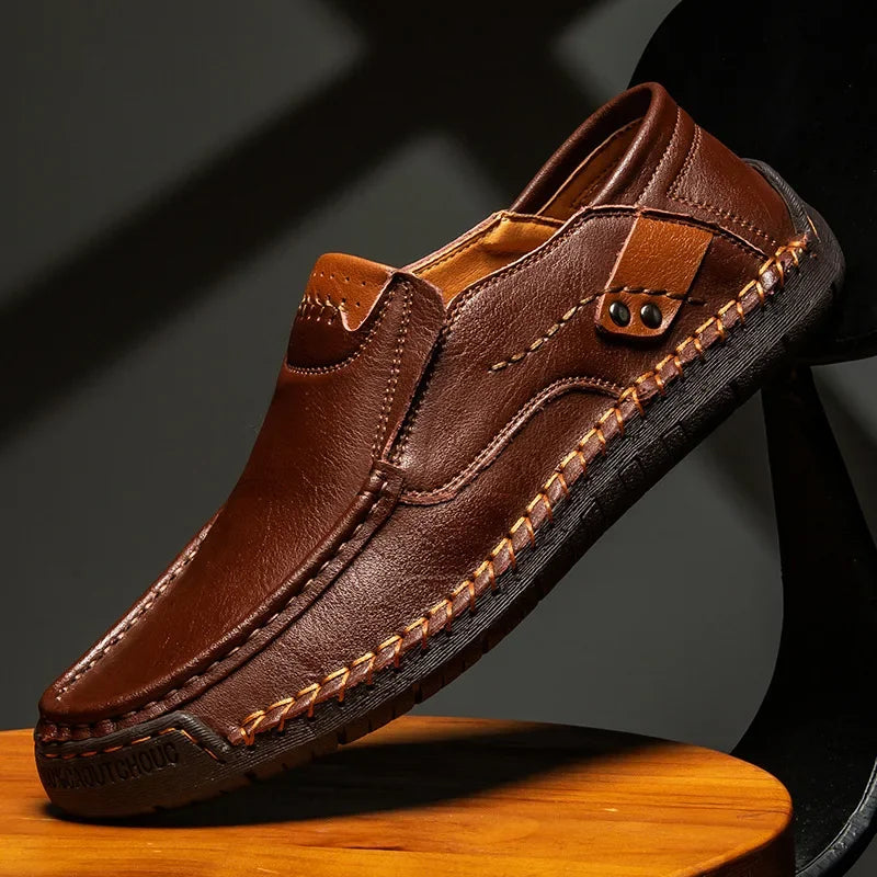 Brown leather shoe on a wooden surface with a dark background
